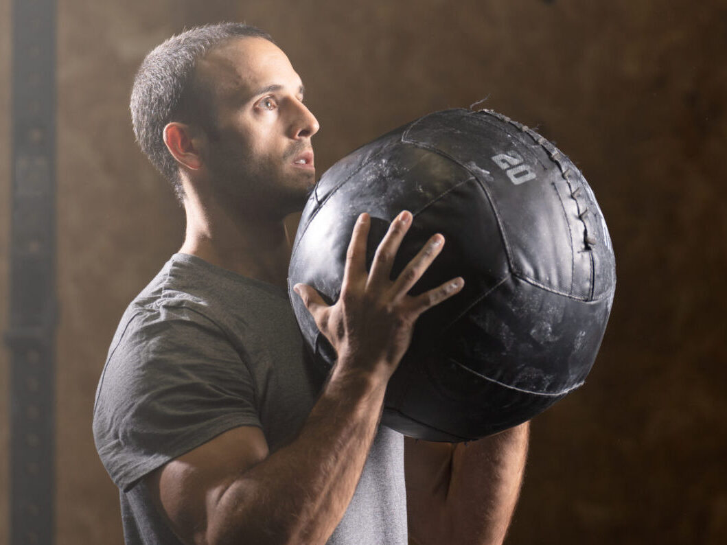 Portrait of man using medicine ball